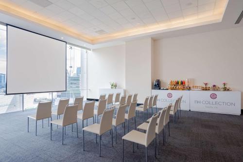 a conference room with chairs and a projection screen at NH Collection Mexico City Santa Fe in Mexico City