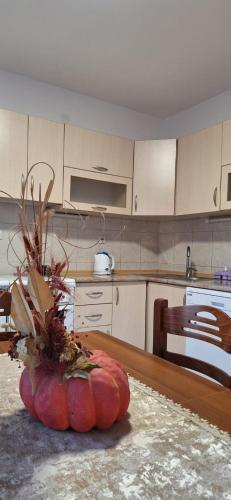 a large orange pumpkin sitting on a table in a kitchen at Apartments Aurora in Bar