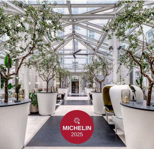 a greenhouse with trees and chairs and a sign that says mitzelin at H15 Boutique Hotel, Warsaw, a Member of Design Hotels in Warsaw