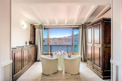 a dining room with a table and a large window at Hotel Castel Vecchio in Castel Gandolfo