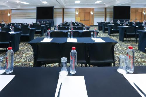 a conference room with tables and chairs with bottles on them at Garden Court Nelson Mandela Boulevard in Cape Town