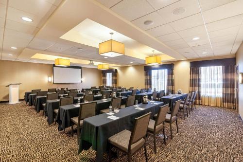 a conference room with tables and chairs and a screen at Cambria Hotel Pittsburgh - Downtown in Pittsburgh