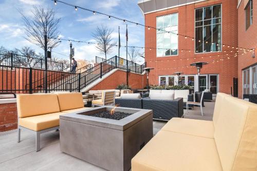 a patio with chairs and a fire pit in front of a building at Cambria Hotel Pittsburgh - Downtown in Pittsburgh