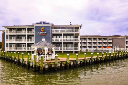a hotel on the water with a dock at Comfort Suites Chincoteague Island Bayfront Resort in Chincoteague