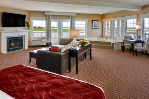 a large living room with a couch and a fireplace at Comfort Suites Chincoteague Island Bayfront Resort in Chincoteague