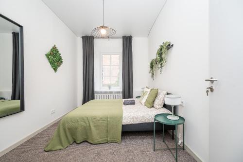 a bedroom with a bed and a window at City Nest Vilnius Oldtown in Vilnius
