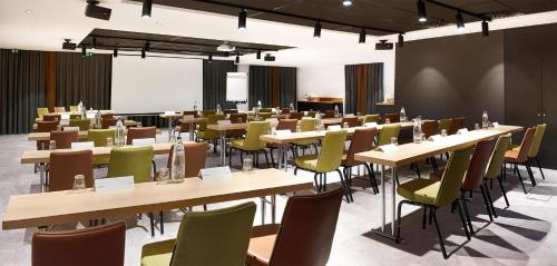 a large room with tables and chairs in it at Park Inn By Radisson Brussels Airport in Diegem