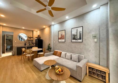 a living room with a couch and a table at Tranquil City Center Wabi Sabi 3BR Townhouse in D1 in Ho Chi Minh City