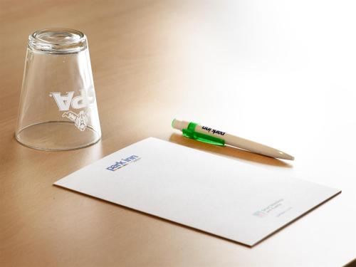 a pen and a bottle on a table at Park Inn By Radisson Brussels Airport in Diegem