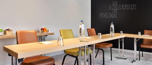 a conference room with a table and chairs at Park Inn By Radisson Brussels Airport in Diegem