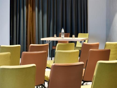 a conference room with a table and chairs at Park Inn By Radisson Brussels Airport in Diegem
