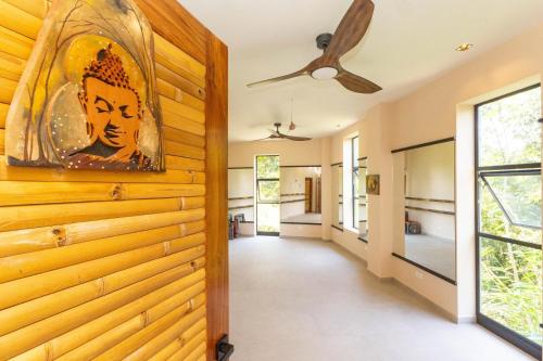 a hallway of a house with a wooden wall at Villa Buddha Belly OceanMountain top views in Quepos