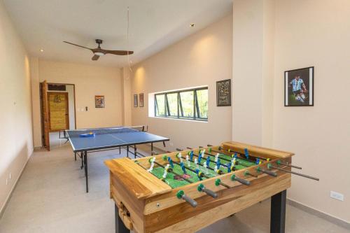 a room with a table and a ping pong ball at Villa Buddha Belly OceanMountain top views in Quepos