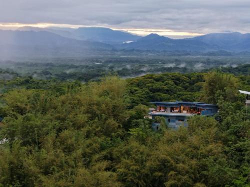 a building in the middle of a forest at Villa Buddha Belly OceanMountain top views in Quepos