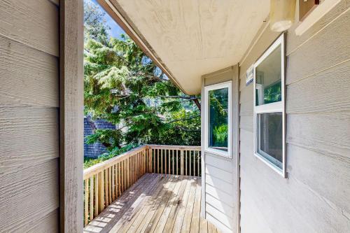 a balcony of a house with a large window at Beach Time Getaway in Lincoln City
