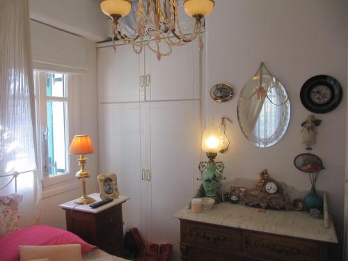 a bedroom with a large white cabinet and a lamp at Diles Complex Apartment in Ornos