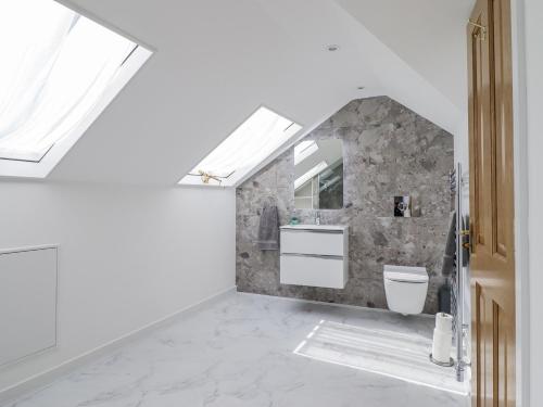 a bathroom with a sink and a toilet at Neptune Cottage in Conwy