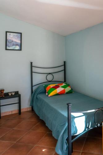 a bedroom with a bed with a pillow and a table at BnB Meridiana in Cana