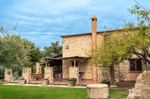 an exterior view of a stone house with a chimney at BnB Meridiana in Cana