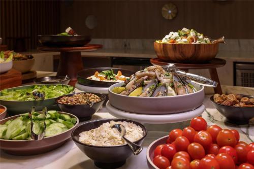 a buffet with many bowls of food on a table at Radisson Hotel & Residence Riyadh Olaya in Riyadh