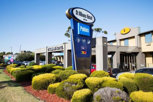 a sign for a gas station in front of a store at Nightcap at St Albans Hotel in St Albans