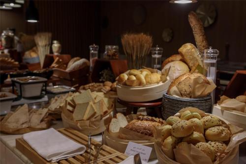 a table filled with lots of different types of bread at Radisson Hotel & Residence Riyadh Olaya in Riyadh