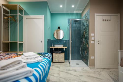 a bathroom with a bed and a shower and a mirror at Experience Napoli Center in Naples