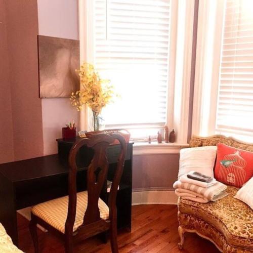 a bedroom with a chair and a desk and a window at Bloomingdale Stays, Washington DC in Washington