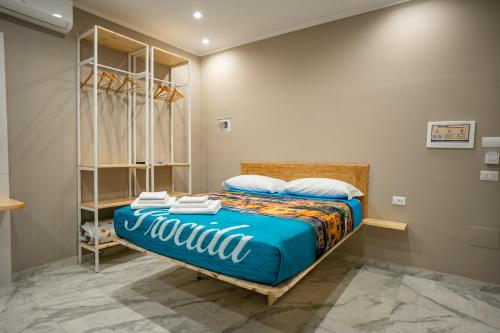 a bedroom with a bed with a blue comforter at Experience Napoli Center in Naples
