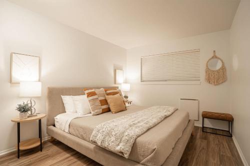 a bedroom with a large bed with white walls at Stylish Bellevue Stay half mile to downtown in Bellevue