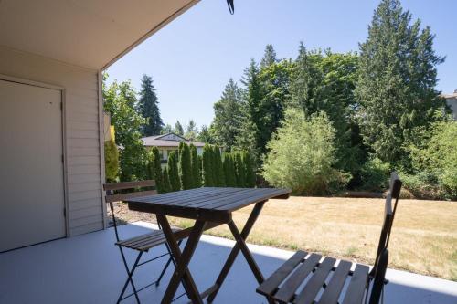 a picnic table and two chairs on a patio at Stylish Bellevue Stay half mile to downtown in Bellevue