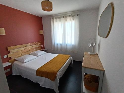a hotel room with a bed and a mirror at A Casuccia - Pétanque in Biguglia