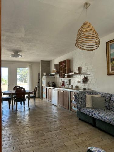 a kitchen and living room with a table and a couch at Villa Vittoria in Solanas
