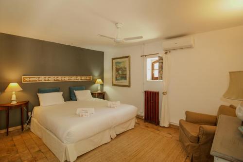 a bedroom with a large white bed and a couch at FLH Belaventura Villa in Boliqueime