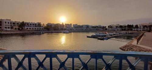 a view of a river with boats in a city at Dream Apartment - Near Beach with Pool View & WiFi in Salalah