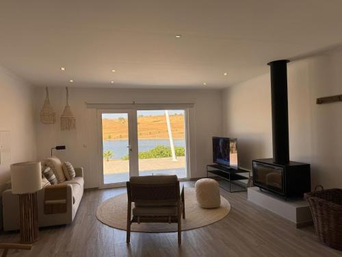 a living room with a couch and a stove at Monte Vale - Nature Resort in Entradas