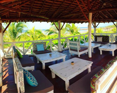 a group of tables and chairs under a pavilion at Tapas & Surf in Petacaltepe
