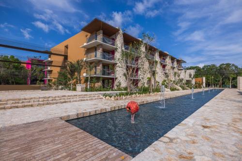 a building with a fountain in front of a building at Hotel Xcaret Mexico All Parks All Fun Inclusive in Playa del Carmen