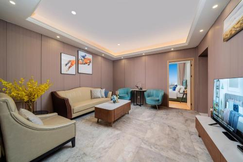 a living room with a couch and a television at Cloudy international apartment Beijing Rd A-mall in Guangzhou