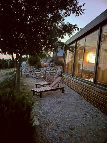 a bench next to a house with a tree at KastHouse Yellow by Vellaris, Luxury Mobile Home in Mali Lošinj