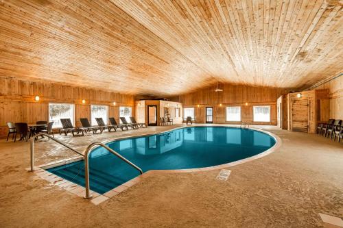 a large swimming pool in a building with a wooden ceiling at Quality Inn Superior - Duluth in Superior