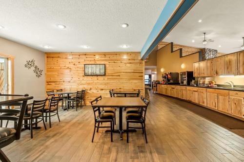 a restaurant with wooden walls and tables and chairs at Quality Inn Superior - Duluth in Superior
