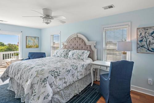 a bedroom with a bed and a desk and a window at Worthington Lane in Kitty Hawk