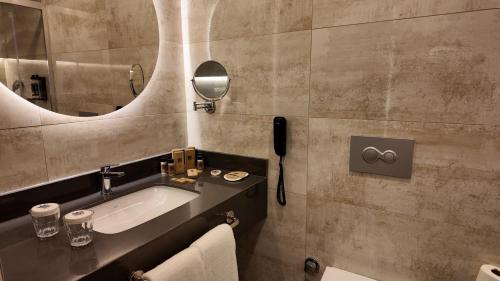 a bathroom with a sink and a mirror at PALEMON Resort& Spa in Manavgat