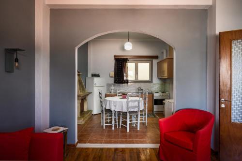 a dining room and kitchen with a table and chairs at Litsa Apartments in Lákka
