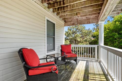 two chairs and a table on the front porch of a house at Worthington Lane in Kitty Hawk