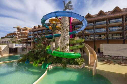 a water slide in a pool at a resort at Hotel Xcaret Mexico All Parks All Fun Inclusive in Playa del Carmen