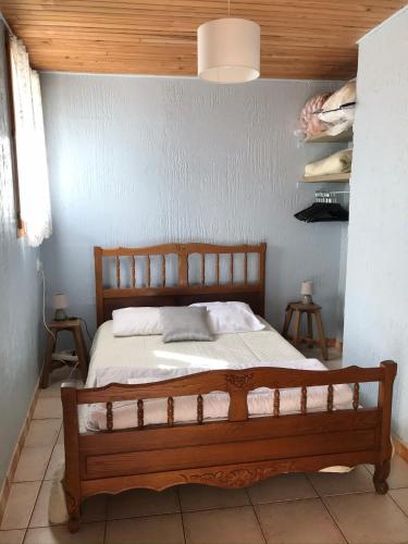 a bedroom with a wooden bed in a room at logements les 4 fontaines in Gavarnie