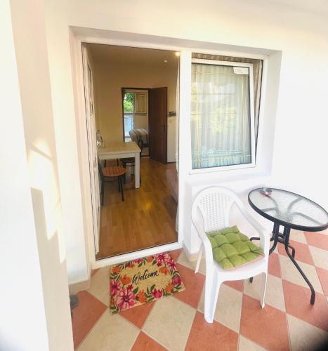 a view of a living room with a table and a chair at Mon in Bar