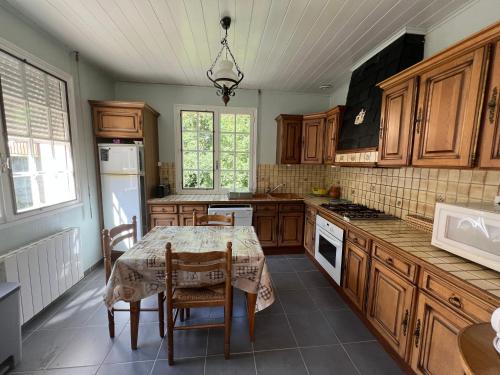 a kitchen with a table and chairs in it at logements les 4 fontaines in Gavarnie